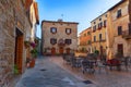 Pienza, Italy Ã¢â¬â May 27, 2017: Beautiful narrow street with sunlight and flowers in the village of Pienza, Italy Royalty Free Stock Photo